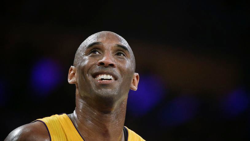 FILE - In this April 13, 2016 file photo, Los Angeles Lakers forward Kobe Bryant smiles during the first half of Bryant's last NBA basketball game, against the Utah Jazz in Los Angeles. Bryant is getting advice from Steven Spielberg, J.J. Abrams and Jerry Bruckheimer as he redirects his competitive drive from professional basketball to his publishing and production company. One month after retiring from the NBA, the Los Angeles Lakers star has a new daily routine. "I get up early and I train and I work out. Then I go to the office," Bryant said in an interview Wednesday, May 18, 2016.(AP Photo/Jae C. Hong, File)