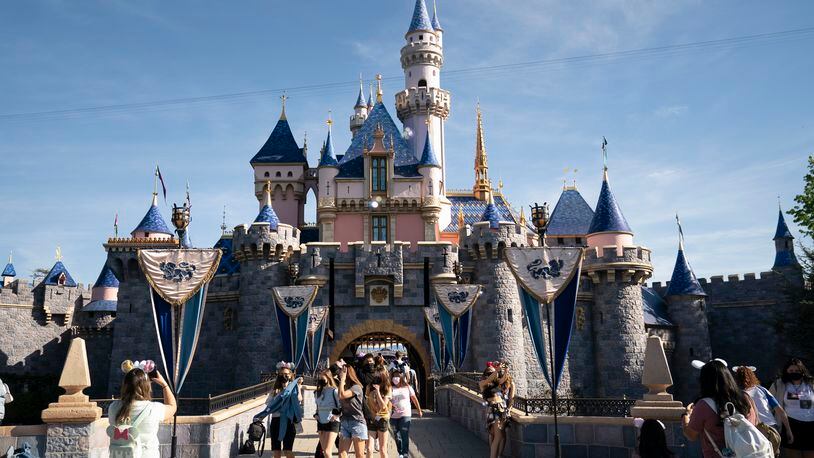 FILE - Visitors pass through Disneyland in Anaheim, Calif., April 30, 2021. (AP Photo/Jae C. Hong, File)