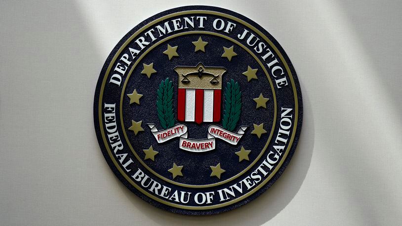 FILE - An FBI seal is seen on a wall on Aug. 10, 2022, in Omaha, Neb. The FBI says scammers stole more than $3.4 billion from older Americans last year. An FBI report released Tuesday shows a rise in losses through increasingly sophisticated tactics to trick the vulnerable into giving up their life savings. (AP Photo/Charlie Neibergall, File)