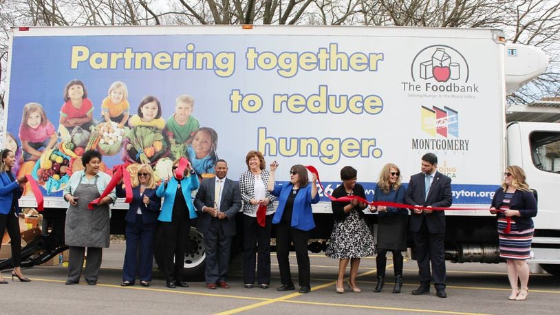 Officials from The Foodbank and Montgomery County unveil a new truck that will provide mobile farmers markets to underserved areas of the community. SUBMITTED