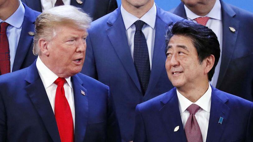 President Donald Trump and Japan's Prime Minister Shinzo Abe talk during a family photo session on the opening day of the Argentina G20 Leaders' Summit 2018 at Costa Salguero on November 30, 2018 in Buenos Aires, Argentina.