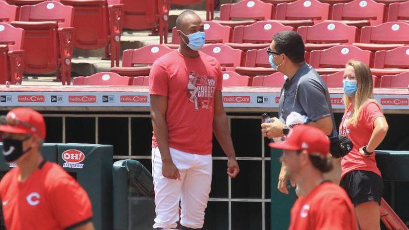 Reds reliever Amir Garrett, center, wears a mask at the first workout of 2020 Summer Camp at Great American Ball Park on Friday, July 3, 2020.