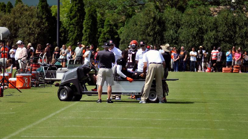 Trainers look at safety George Iloka’s right knee after he injured it during Sunday’s practice. JAY MORRISON/STAFF