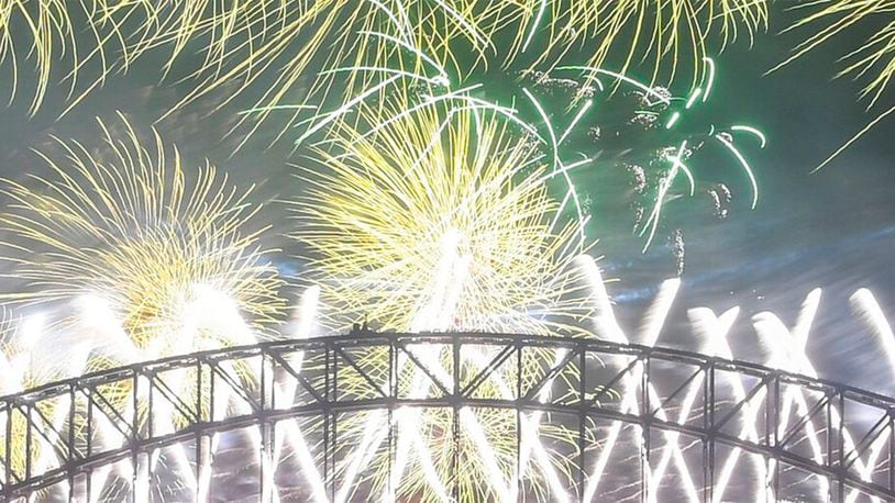 Midnight fireworks explode over the Sydney Harbour Bridge during New Year's eve celebrations in Sydney, Tuesday, Dec.31, 2019.