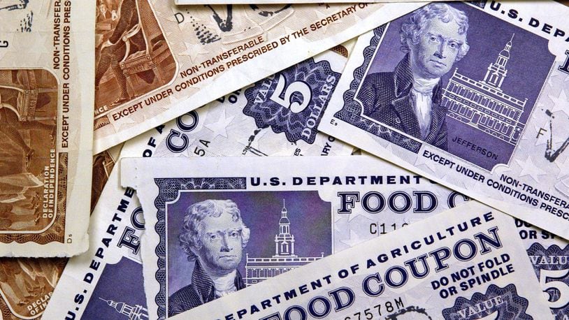 Older, traditional food stamps are displayed. (Photo by Tim Boyle/Getty Images)