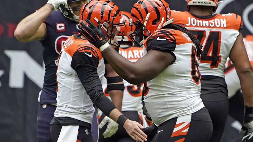 Cincinnati Bengals quarterback Brandon Allen, left, celebrates with center Trey Hopkins after throwing a touchdown pass against the Houston Texans during the first half of an NFL football game Sunday, Dec. 27, 2020, in Houston. (AP Photo/Eric Christian Smith)