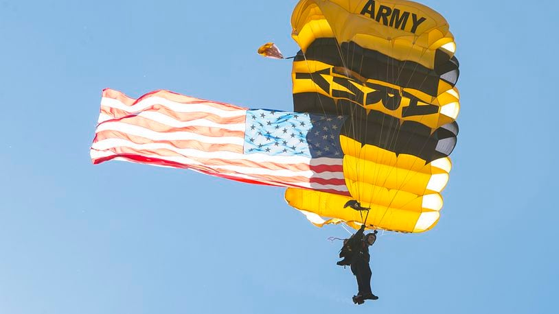 A member of the Golden Knights U.S. Army Parachute Team prepares for landing while flying the American flag at the Dayton Air Show on July 30 this year. U.S. AIR FORCE PHOTO/JAIMA FOGG