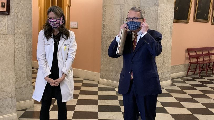 Ohio Gov. Mike DeWine and Ohio Health Department Director Dr. Amy Acton show off home-made protective masks at the Ohio Statehouse on Monday. Photo by Laura A Bischoff. Columbus bureau