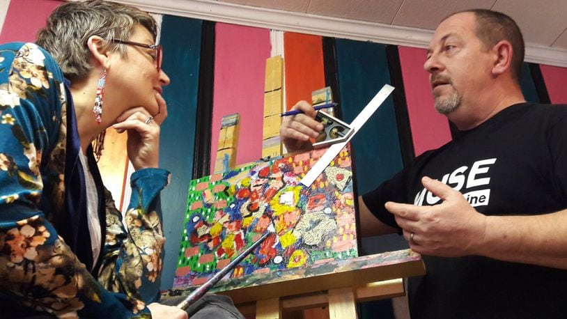 Actor Jake Lockwood helps wife Heather to locate the best viewing angles for a piece of art she’s working on in her Beavercreek home studio, where she offers a wide range of classes and special projects and events for all ages. CONTRIBUTED