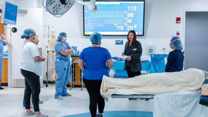 Deborah Atkinson, program director of the Sinclair Community College Medical Assistant Program, prepares 
Kettering Health professionals for an exercise in Sinclair’s Simulation Center. CONTRIBUTED