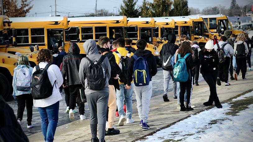 Stebbins high school students prepare to board buses after their first day back to school Tuesday, Jan. 18, 2022. Mad River school district had been doing online learning since last Thursday. MARSHALL GORBY \STAFF