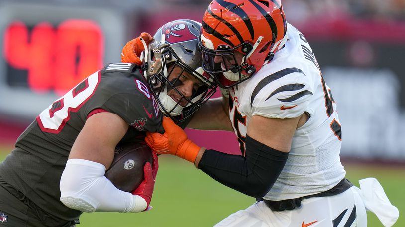 Tampa Bay Buccaneers tight end Cade Otton (88) is stopped by Cincinnati Bengals linebacker Logan Wilson (55) during the first half of an NFL football game, Sunday, Dec. 18, 2022, in Tampa, Fla. (AP Photo/Chris O'Meara)