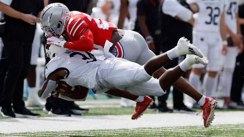 Ohio State defensive back Cameron Brown, top, tackles Arkansas State running back Marcel Murray during the first half of an NCAA college football game Saturday, Sept. 10, 2022, in Columbus, Ohio. (AP Photo/Jay LaPrete)
