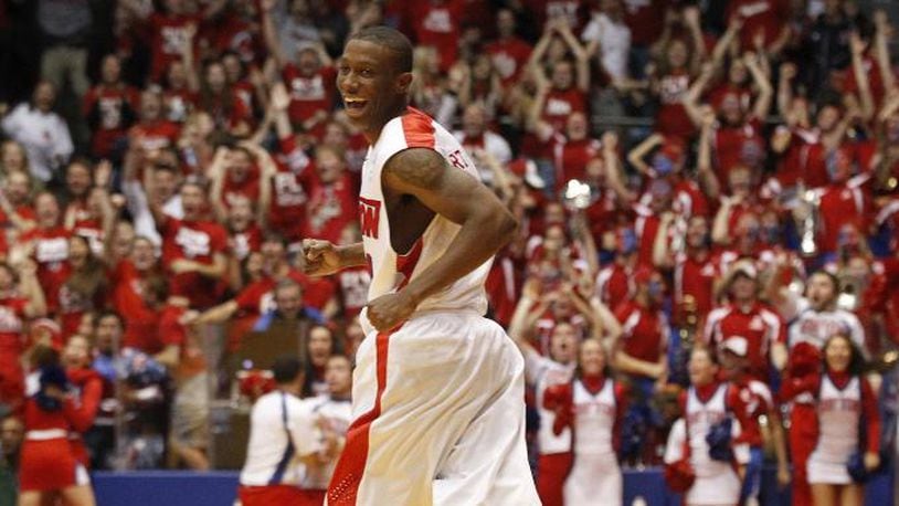 Jordan Sibert smiles as he runs back up court after a game-winning 3-pointer with 1 second left against IPFW on Saturday, Nov. 9, 2013, at UD Arena. David Jablonski/Staff