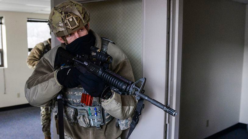 A member of the 88th Security Forces Squadron secures a room during an active-shooter exercise at Wright-Patterson Air Force Base, Ohio, Feb. 24, 2021. Readiness exercises are routinely held to streamline unit cohesion when responding to emergencies. (U.S. Air Force photo by Wesley Farnsworth)