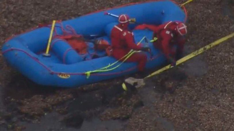 Emergency crews work to rescue a cow from the water. (Photo: WSOCTV.com)