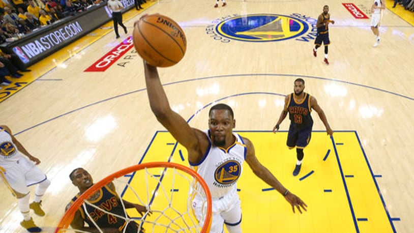 Golden State Warriors forward Kevin Durant (35) dunks against the Cleveland Cavaliers during the first half of Game 1 of basketball's NBA Finals in Oakland, Calif., Thursday, June 1, 2017. (Ezra Shaw/Pool Photo via AP)