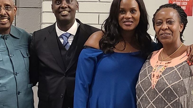 From left:  The Rev. Peter Mutima from Maine, the Rev. Laurent Muvunyi of Dayton, his wife, Nicole Muvunyi, and the Rev. Muke Nagaju from Rwanda at Muvunyi's ordination July 25 at Living Hope Church in Centerville. CONTRIBUTED