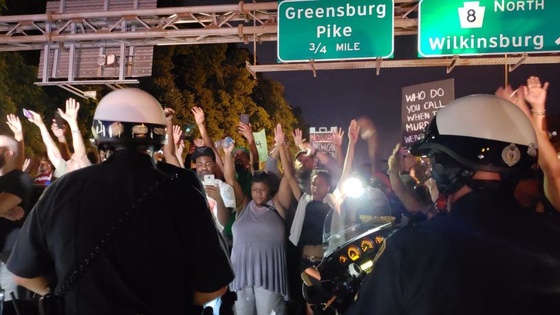 Pittsburgh police are searching for the driver of a car that plowed into a group of protesters Friday night, demonstrating against police use of force in the shooting death of 17-year-old Antwon Rose.