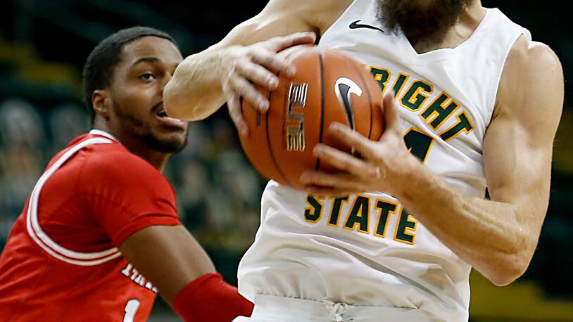 Wright State guard Tim Finke pulls down a defensive rebound in front of Miami forward Josh Brewer during a mens basketball game at the Nutter Center in Fairborn Saturday, Dec. 5, 2020. E.L. Hubbard/CONTRIBUTED