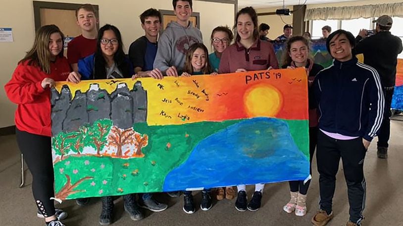 Carroll High School seniors display a hand-painted banner they made during PATS (Praying and Thinking Spiritually) Retreat in February 2019 at Camp Kirkwood in Wilmington. Each year, approximately 150 Carroll seniors participate in this voluntary retreat led by their classmates. Contributed photo