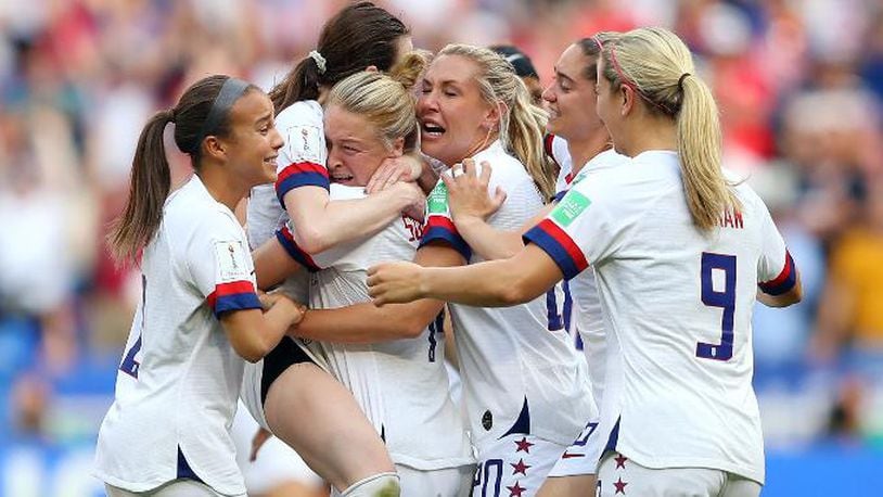 Rose Lavelle celebrates with Emily Sonnett and USA teammates following the 2019 FIFA Women's World Cup France Final match between the United States and the Netherlands at Stade de Lyon on July 07, 2019, in Lyon, France. (Photo by Richard Heathcote/Getty Images)