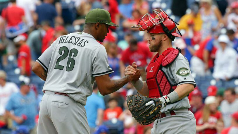 PHILADELPHIA, PA - MAY 28: Closer Raisel Iglesias #26 of the Cincinnati Reds is congratulated by Tucker Barnhart #16 after the final out of a game against the Philadelphia Phillies at Citizens Bank Park on May 28, 2017 in Philadelphia, Pennsylvania. The Reds won 8-4. (Photo by Hunter Martin/Getty Images)