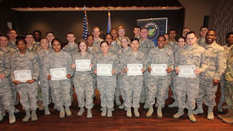 Col. Thomas Sherman (left), 88th Air Base Wing and installation commander, Chief Master Sgt. Stephen Arbona (second from right), 88th Air Base Wing command chief, and Col. Elena Oberg (right), Air Force Research Laboratory vice commander, stand with the newest Team Wright-Patt enlisted promotees during a ceremony at the Wright-Patterson Theater Feb. 28. (U.S. Air Force photo/Thomas Lewis)