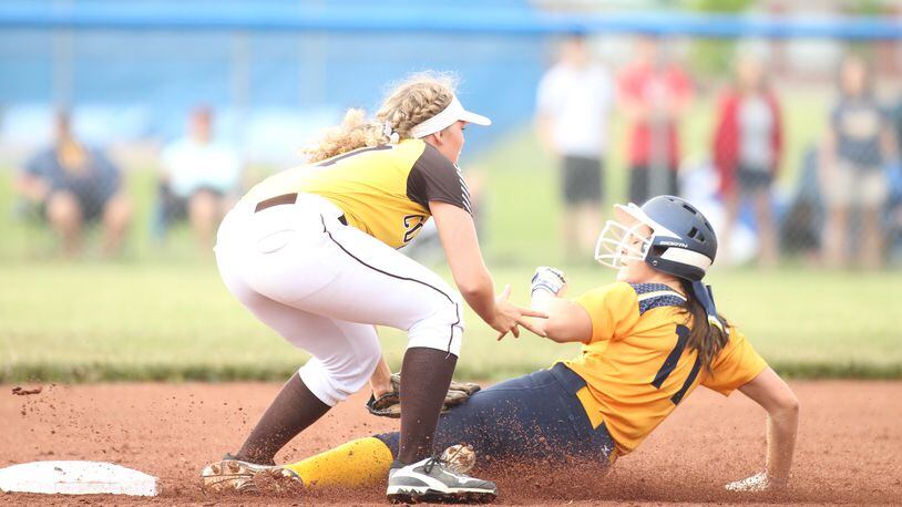 Kenton Ridge’s Lexee Trainer tags out Monroe’s Faith Hensley in a Division II district final on Sunday, May 20, 2018, at Brookville High School. David Jablonski/Staff