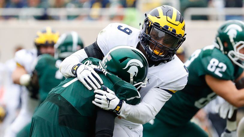 EAST LANSING, MI - OCTOBER 29: Mike McCray #9 of the Michigan Wolverines sacks quarterback Tyler O’Connor #7 of the Michigan State Spartans during the second quarter of the game at Spartan Stadium on October 29, 2016 in East Lansing, Michigan. (Photo by Leon Halip/Getty Images)