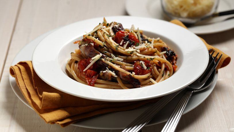 Long strands of bucatini, the pasta with a hole down the middle, are tossed with roasted tomatoes, radicchio and garlic. Styled by Mark Graham. (E. Jason Wambsgans/Chicago Tribune/TNS)