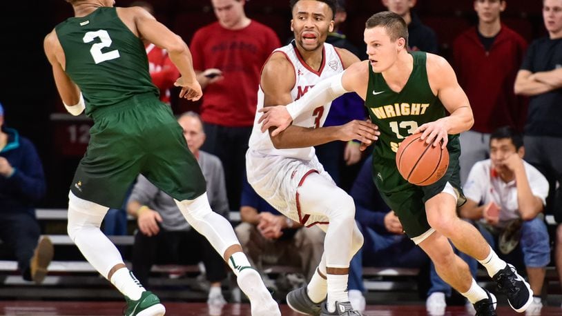 Wright State’s Grant Benzinger dribbles around Miami’s Jalen Adaway during their game Tuesday, Nov. 14 at Millett Hall on the Miami University Campus in Oxford. The Miami University Redhawks basketball team defeated the Wright State Raiders 73-67 in overtime. NICK GRAHAM/STAFF