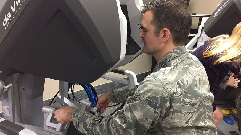 Maj. (Dr.) Toby Lees, urologist, Surgical Specialties Flight commander, 88th Medical Group, manipulates the da Vinci Xi surgical robotic system from one of its two consoles during the new system’s unveiling at the Wright-Patterson Medical Center April 20. (Skywrighter photo/Amy Rollins)