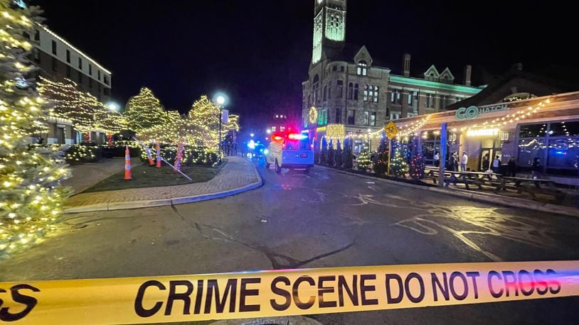 The area around Springfield’s downtown Esplanade was taped off as a crime scene after a man was reportedly shot in the parking lot of the Clark County Heritage Center Friday night following the Holiday in the City celebration. BILL LACKEY/STAFF