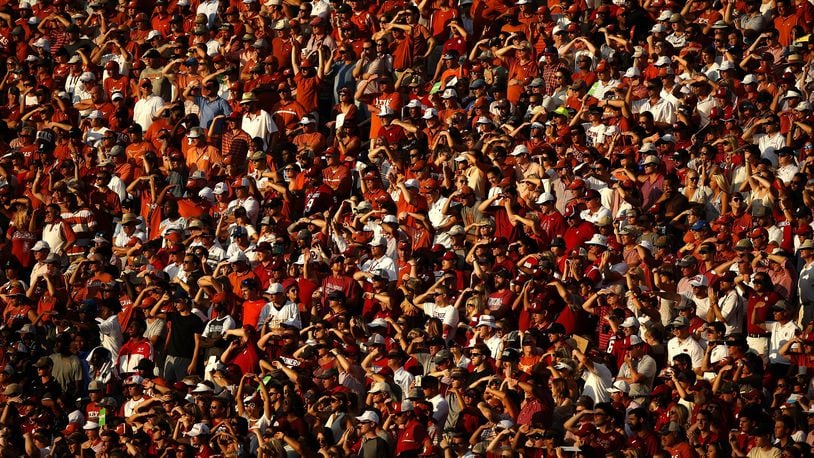 Texas and Oklahoma fans watch during the second half of an NCAA college football game Saturday, Oct. 14, 2017, in Dallas. Oklahoma won 29-24. (AP Photo/Ron Jenkins)