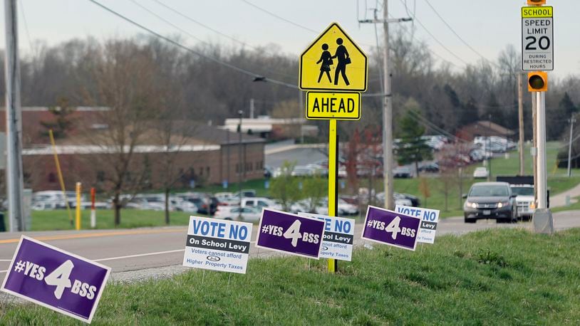 Levy campaign signs have popped up like spring flowers everywhere in Bellbrook, including this stretch at the corner of Upper Bellbrook and Feedwire Roads near Bellbrook High School. TY GREENLEES / STAFF