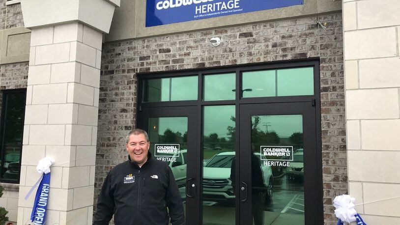 Managing Partner Ron Sweeney stands outside Coldwell Banker Heritage’s new office on Yankee Street.