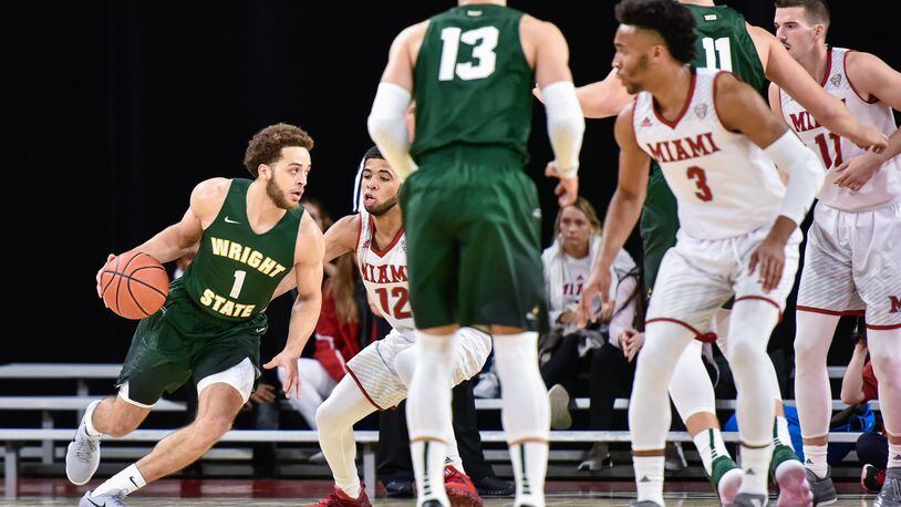 Wright State’s Justin Mitchell dribbles the ball during their game Tuesday, Nov. 14 at Millett Hall on the Miami University Campus in Oxford. The Redhawks defeated the Raiders 73-67 in overtime. NICK GRAHAM/STAFF