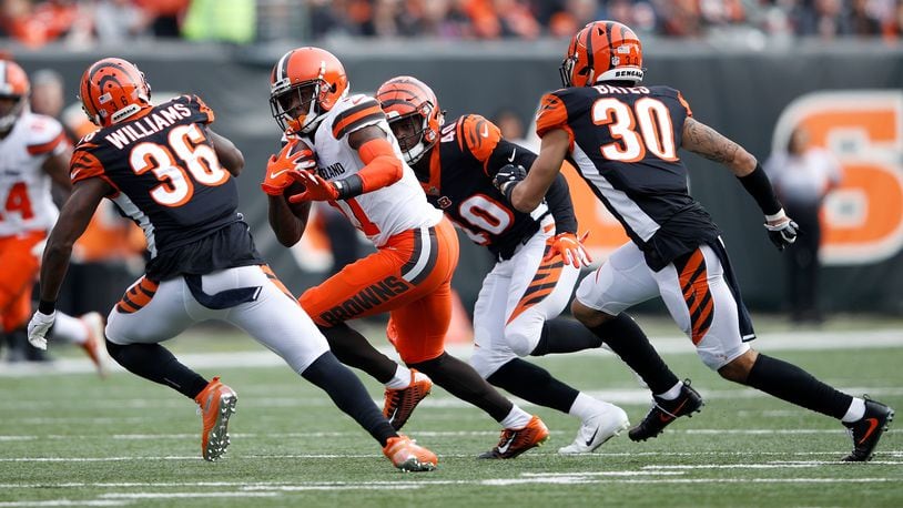 CINCINNATI, OH - NOVEMBER 25: Antonio Callaway #11 of the Cleveland Browns attempts to get past Shawn Williams #36 of the Cincinnati Bengals, Brandon Wilson #40, and Jessie Bates #30 during the second quarter at Paul Brown Stadium on November 25, 2018 in Cincinnati, Ohio. (Photo by Joe Robbins/Getty Images)