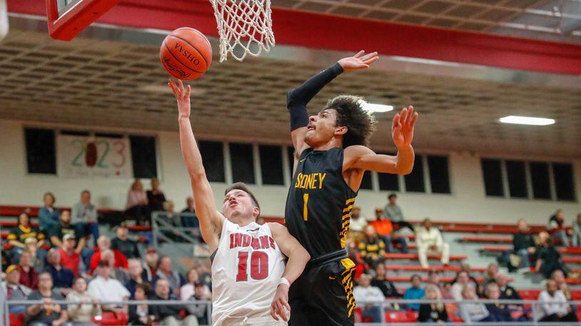 Sidney’s Dominick Durr leaps to block Stebbins’ Daniel Bowman during their game on Friday, Jan. 24. The Yellow Jackets overcame an 18-point deficit to win 72-59. CONTRIBUTED PHOTO BY MICHAEL COOPER