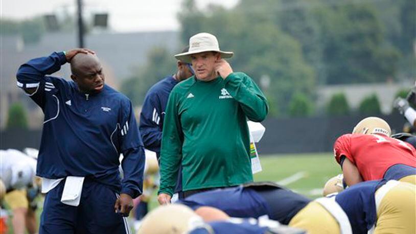 Notre Dame offensive coordinator Chuck Martin, right, talks with assistant coach Tony Alford during practice of a NCAA college football Aug. 22, 2013 in South Bend, Ind. Martin was hired Tuesday Dec. 3, 2013 as the head coach at Miami of Ohio, which is coming off one of the worst seasons in its history. (AP Photo/Joe Raymond)