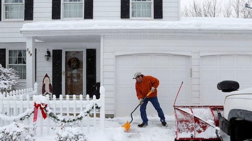 After shoveling a client's driveway, Chris Wade shovels the walkway. Wade worked at Delphi Automotive Systems for 13 and a half years before taking a buyout in 2006 as part of the company's ongoing shift of production out of the U.S. (Katie Falkenberg/Los Angeles Times/TNS)