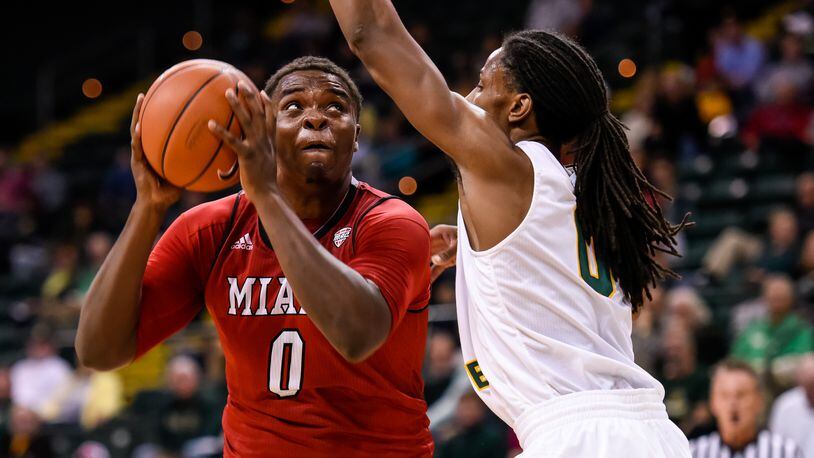Wright State University's Steven Davis defends a shot by Miami University's Darius Harper during the first half of their game against Tuesday, Nov. 15 at the Nutter Center at Wright State University in Fairborn. NICK GRAHAM/STAFF