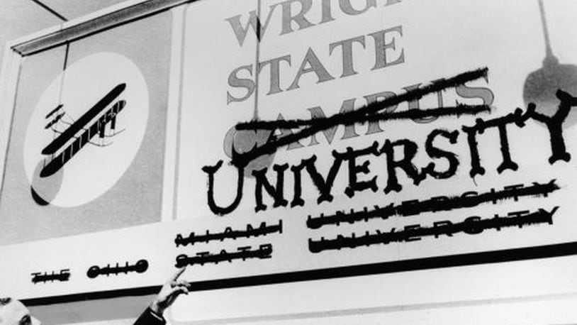 Wright State’s first president, Brage Golding, points at a former Wright State Campus sign. The school became an independent institution in 1967 and is celebrating its 50th anniversary this fall.