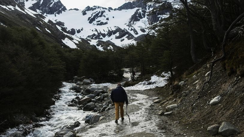 A man walks along a runoff stream below the retreating Martial Glacier on November 9, 2017 in Ushuaia, Argentina. Ushuaia is situated along the southern edge of Tierra del Fuego. The city's main fresh water supply comes from the retreating Martial Glacier, which may be at risk of disappearing. In a 2015 report, warming temperatures led to the loss of 20 percent of the mass and surface of glaciers in Argentina over the previous 50 years. (Photo by Mario Tama/Getty Images)