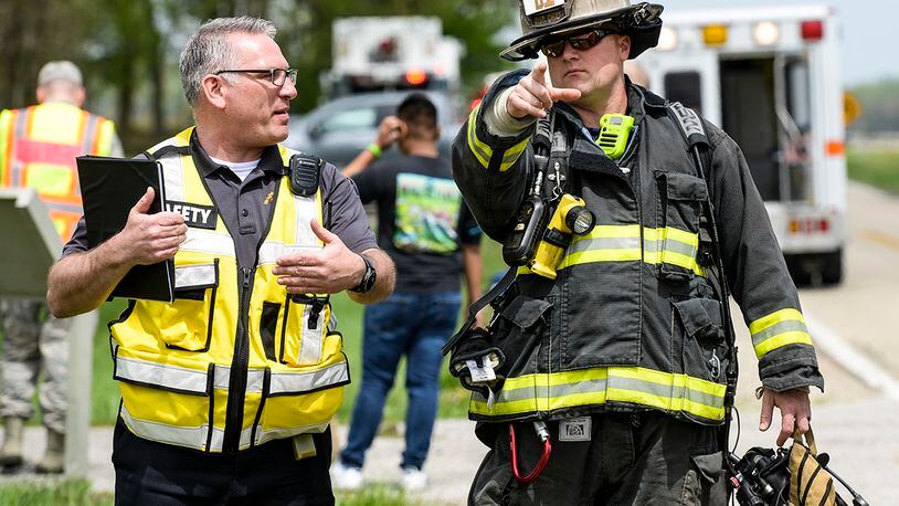 A firefighter from the 788th Civil Engineer Fire Department talks with an individual from the 88th Air Base Wing safety office during a base exercise at Huffman Prairie Flying Field, Wright-Patterson Air Force Base on May 2, 2019. U.S. AIR FORCE PHOTO/WESLEY FARNSWORTH