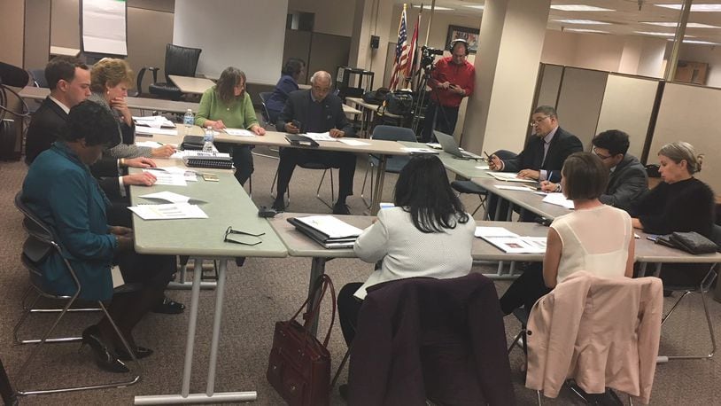 Current and future members of Dayton’s school board discuss leadership roles with district administrators during their Dec. 19, 2017 meeting. JEREMY P. KELLEY / STAFF