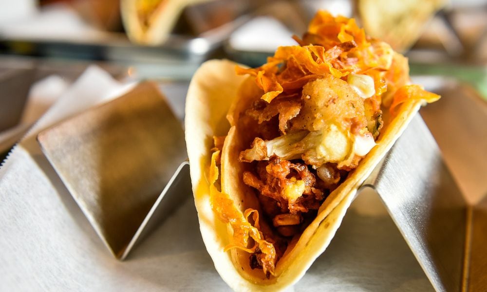 This is The Bang Bang taco with crispy cauliflower, corn fritters, queso and spicy crispy carrots. NICK GRAHAM/STAFF