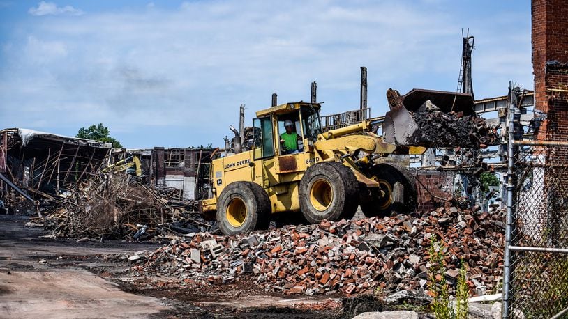 Crews from Vickers Demolition work to dismantle what is left a week after a massive warehouse fire on Laurel Avenue Wednesday, July 31 in Hamilton. The fire started just before 5 a.m. Thursday, July 25, 2019. NICK GRAHAM / STAFF