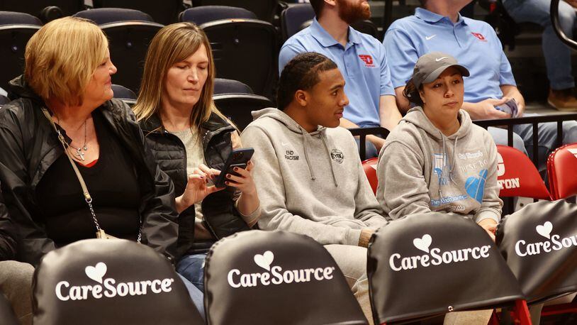 Durral Brooks, second from right, watches a Dayton game against SMU from behind the bench on Nov. 13, 2022, at UD Arena. David Jablonski/Staff